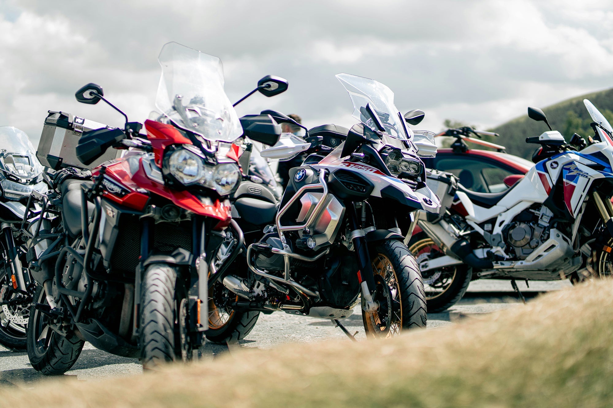A row of adventure motorcycles parked.